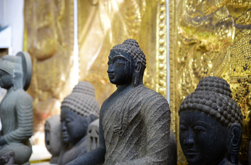 Stone statue of meditating Buddha in Gangaramaya temple, Colombo, Sri Lanka