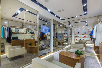 Boutique salon with different stylish fashionable clothes and shoes. Fashionable clothes in boutique