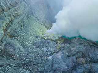 Aerial view from drone to Kawah Ijen volcano crater with sulfur fume. Banyuwangi, East Java, Indonesia