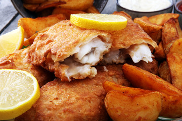 traditional British fish and chips with potato and lemon