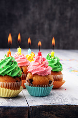 Tasty cupcakes on wooden background. Birthday cupcake in rainbow colors