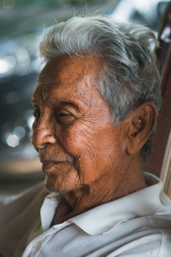 Asian old man sitting on chair