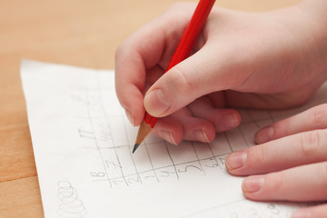 Pencil writing game points on a sheet of paper when playing board games