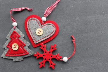 Three Christmas toys from wool  on grey wood background closeup. You can use as the background