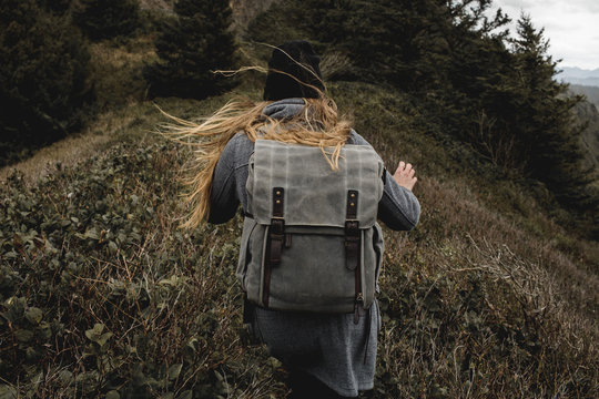 Young Woman Hiking Windy Trail