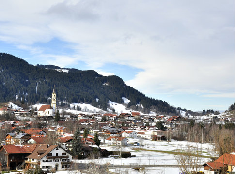 The view of nature in the early spring of the commune in Germany, in Bavaria called Pfronten, located on the border with Austria, in the valley surrounded by the Alps. The village has a beautiful whit