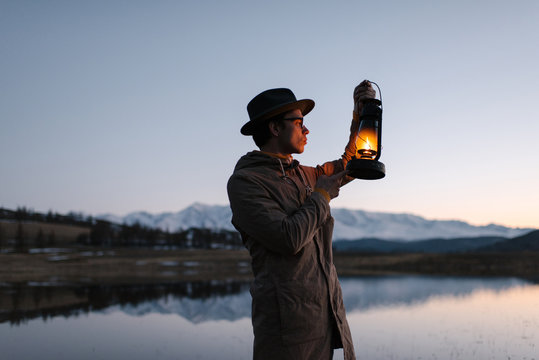 Man looking at lantern
