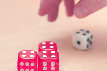 Playing board games, dices in child hand