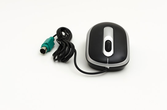 Black and silver mouse with a scroll wheel for a laptop or desktop computer. Connecting by using a PS2 style socket. Isolated on a white background.
