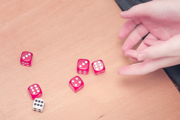 Playing board games, dices in child hand