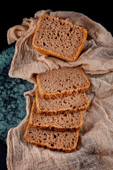 fresh wholegrain bread sliced decorated on a napkin in the kitchen