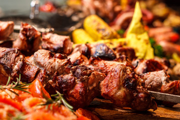 Fresh, hot, fried, appetizing shish kebab cooked on the grill on the coals.