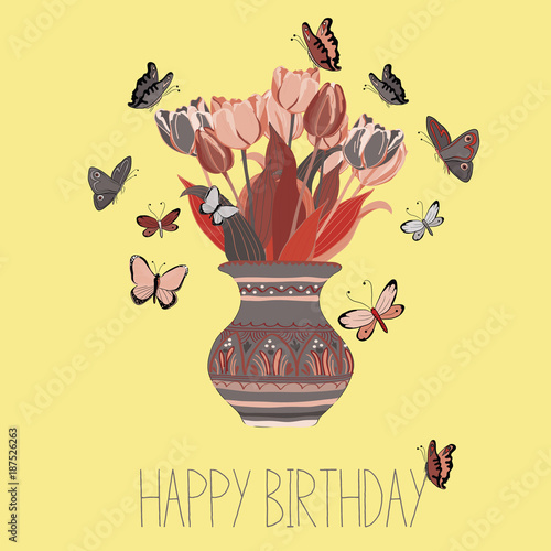 "Beautiful colorful tulips in spanish style vase with butterflies