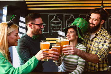 Group of Friends Celebrating St Patrick's Day in Beer Pub