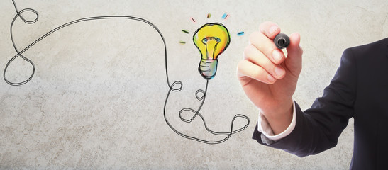 Light Bulb with businessman on gray wall background