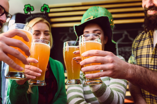 Group of Friends Celebrating St Patrick's Day in Beer Pub