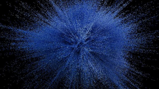 Colorful powder particles fly after being exploded against black background