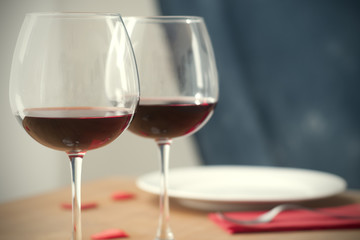 Dinner table with two wine glassis a plate and a fork