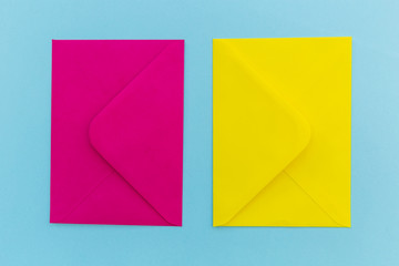 Colorful pink and yellow envelopes on blue background