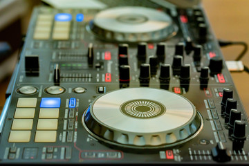 Close-up of DJ's audio mixing console
