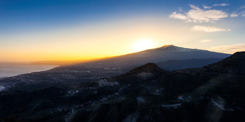 Sunset over the volcano Mount Etna and the gulf of Catania viewed from Taormina, Sicily, Italy, Europe