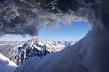 Looking out onto the Alps Through an ice cave on Mont Blanc, Switzerland