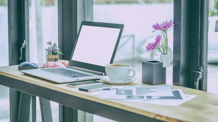 Close Up of woman hands using mobile phone and laptop computer with blank copy space screen for your advertising text message or content business at a coffee shop with a document.