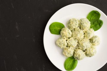 Spinach gnocchi with fresh green on white plate with copy space