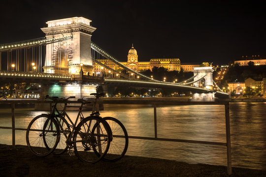 Szechenyi chain bridge and Royal Palace building at night