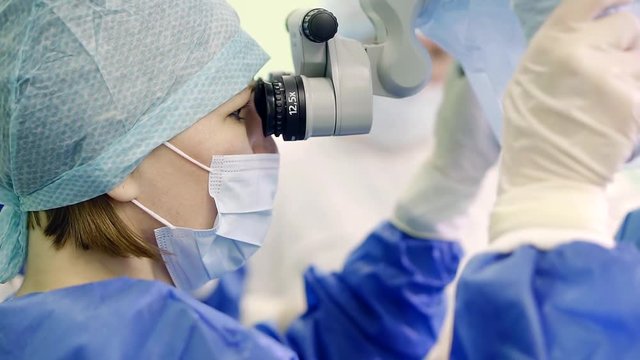 operating surgeon is controlling a progress of the operation using large medical microscope