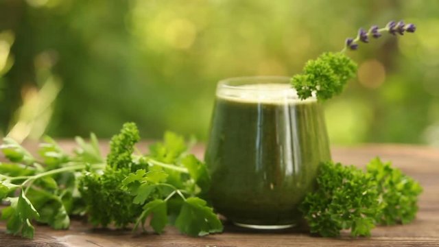 parsley and celery juice in glass on a wooden table