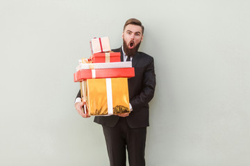 Funny man looking at camera with shocked face, holding box