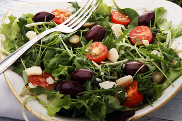 Salad with cheese and fresh vegetables and arugula. Greek salad.