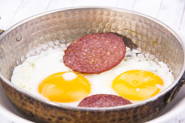 Frying eggs with sausage, Turkish Breakfast