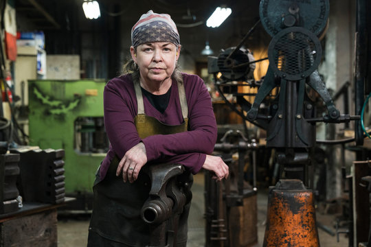 Portrait of woman in blacksmith shop