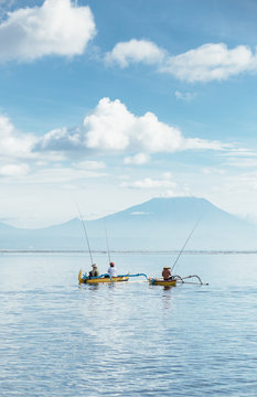 Fisherman fishing from boat in sea