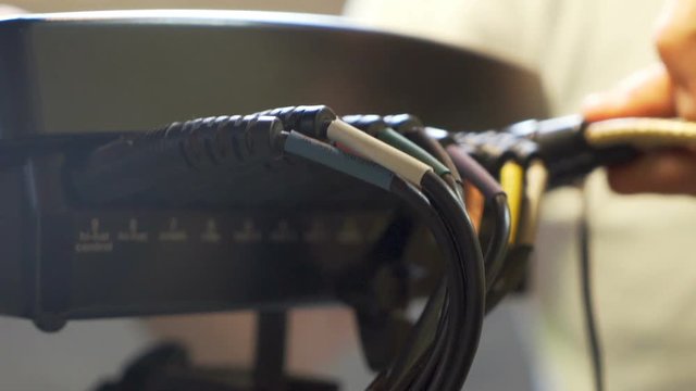 Hand connecting some wires to electric drums.