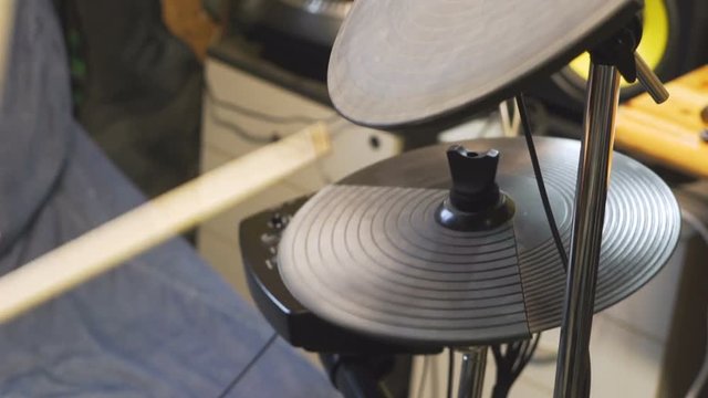 Drum sticks beating on an electric hi-hat cymbal.