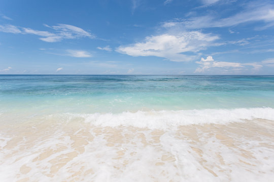 Fototapeta White sand beach with blue cyan water