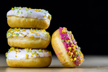 Tasty and fresh donuts on the kitchen table. Cookies, tasty snacks on a wooden table. Table in kuchi.