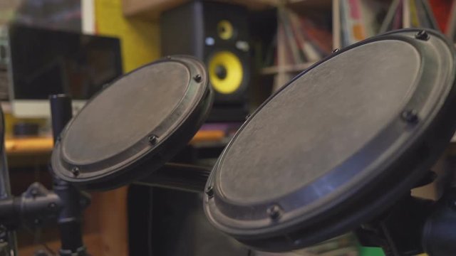 Drum sticks beating on electric tom-toms.