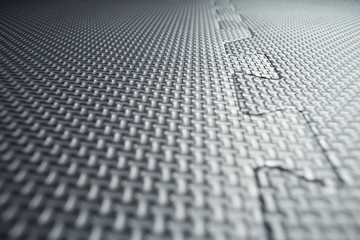 Heavy duty black rubber flooring tiles inside a gym, dance studio, factory, industrial clean room,...
