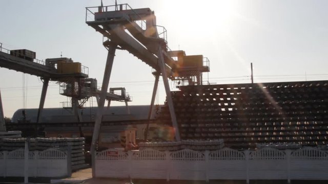 Rail crane transports assembled sections of rails and sleepers.
