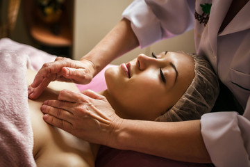 calm girl having spa facial massage in luxurious beauty salon