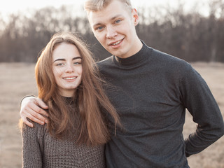Fototapeta premium Handsome young man and girl together outdoors at sunset