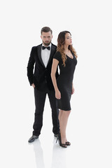 pair of men and women posing for the camera in a studio