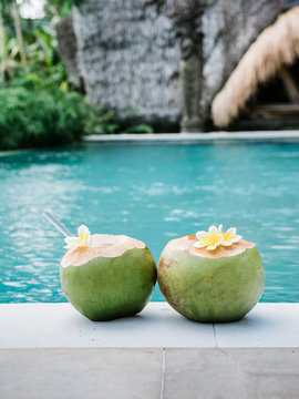 Exotic cocktails served in green coconuts