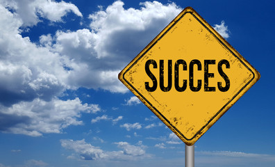 Succes metallic vintage sign over blue sky with clouds