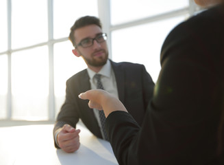 Two business colleagues sitting at a table, having a meeting