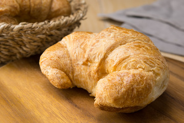 fresh croissant on wooden cutting board